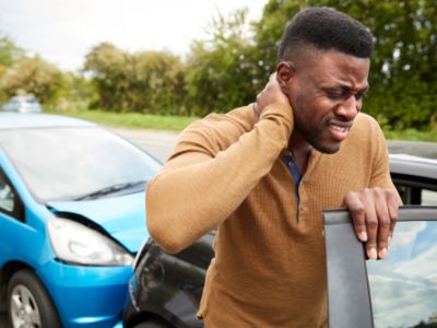 man with hand on neck after car accident