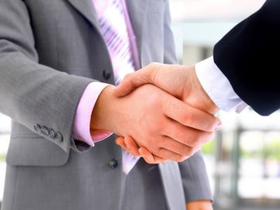 Two men in suits shaking hands