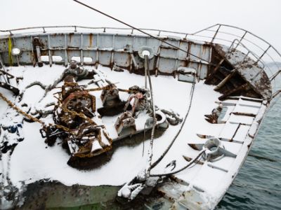 Boat covered in snow tilting over