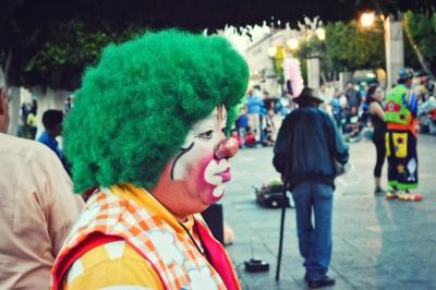 Clown with sad expression looking forward 