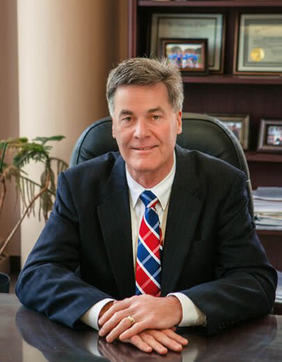 John Hoekstra in suit at desk