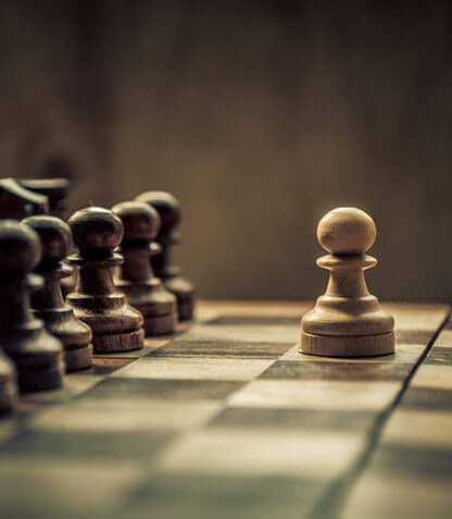 Chess pieces, one stands alone