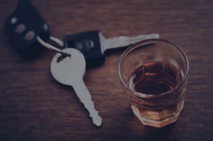 Keys next to alcoholic drink