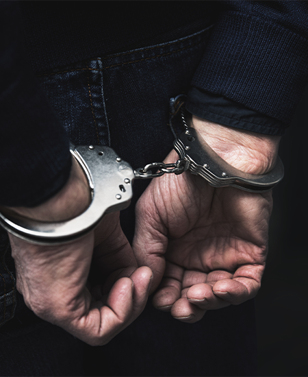 Handcuffed Arrested Man Behind Prison Bars