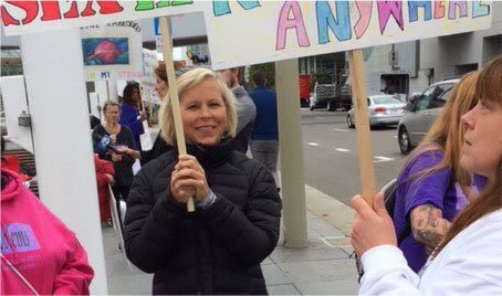 Holly Ennis holding a sign