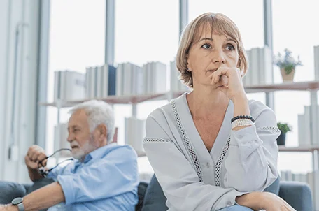 Two older adults looking away form each other