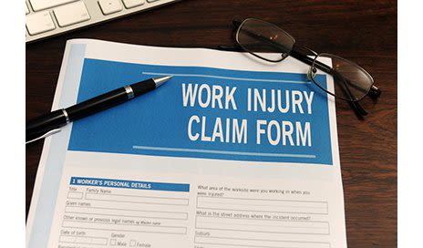 Work Comp Claim Form paper on desk