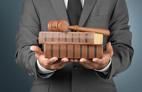 Businessman with books and gavel