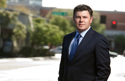 Attorney Roman Kostenko posing outside