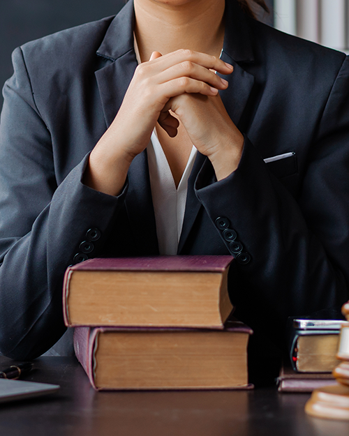 female lawyer working in office with contract and law books