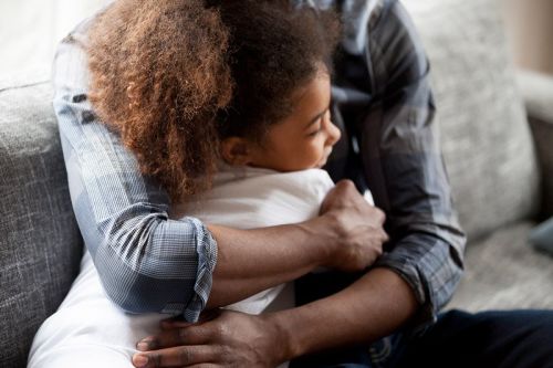 Young girl hugging a man