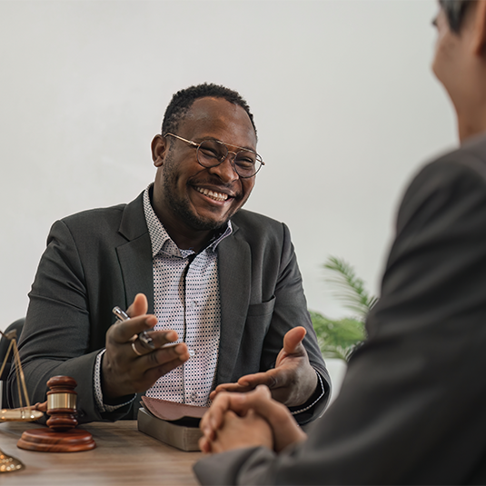 Business team and lawyers discussing contract papers sitting at the table