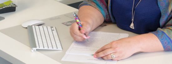 woman writing on a piece of paper