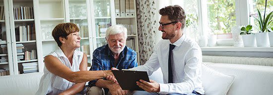 An older couple meeting with an attorney to review some documents