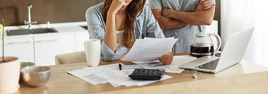 Couple going over bankruptcy documents in their kitchen