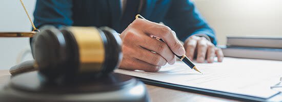 Attorney writing on documents