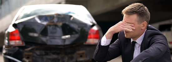 Desperate Man Sitting Asphalt on Crashed Car Background, Automobile Accident