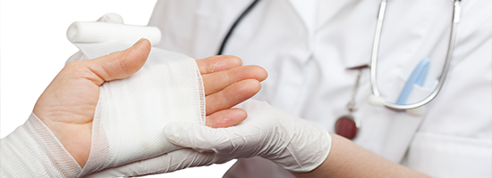 Person wrapping gauze around another person's hand