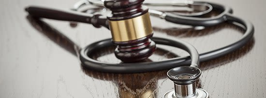 Stethoscope with gavel on wood table.jpg