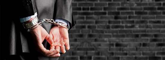 Cropped image of male hands in handcuffs