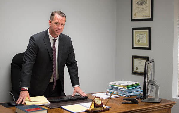 Attorney Charles Boylston Standing at Office Desk