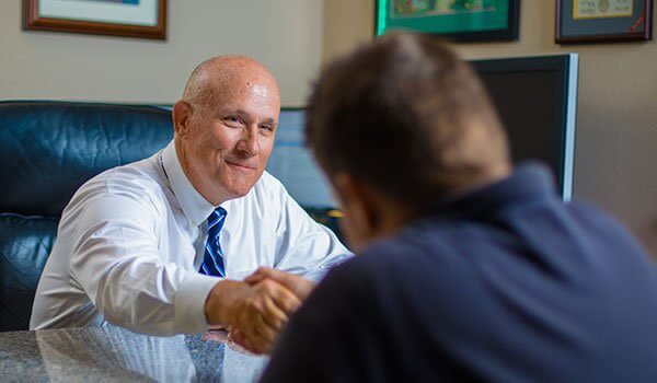 Attorney Steven L. Day Shaking Hands with a Client