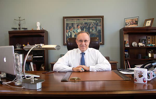 Attorney Wayne C. Arnett in White Shirt Sitting in Office