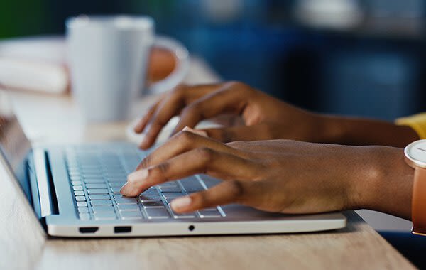 Woman typing at her computer