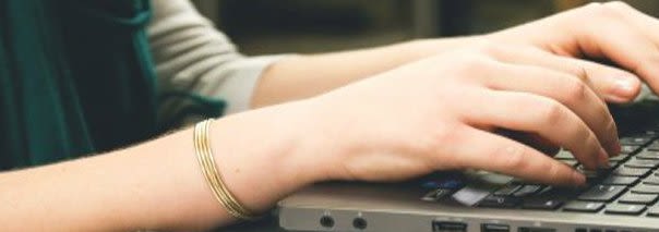 Person Typing on a Keyboard