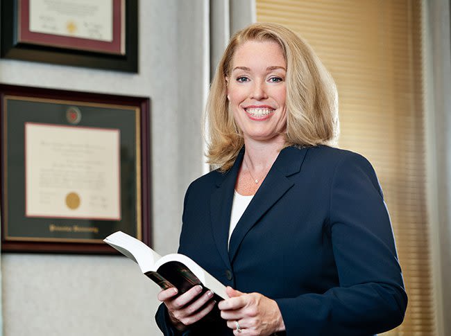 Attorney Jennifer Walker holding a book