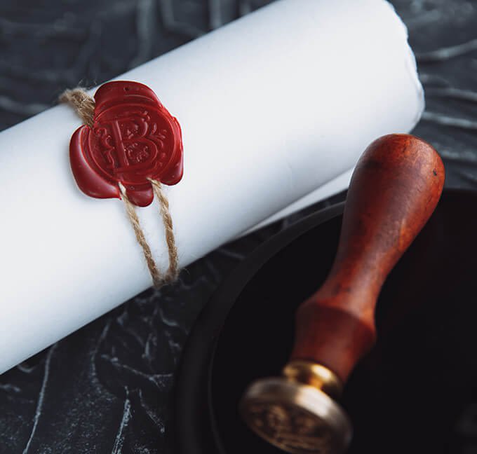 Rolled up document next to a stamp