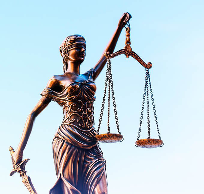 Lady of justice statue with the sky in the background