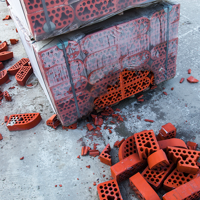 Stack of silicate bricks with the piles of beaten bricks