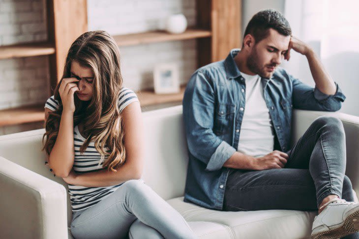 Couple on couch ignoring each other