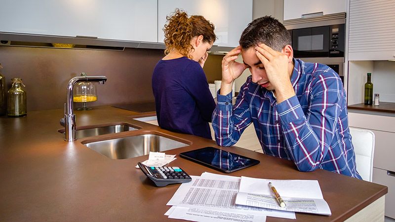People stressing about finances in the kitchen
