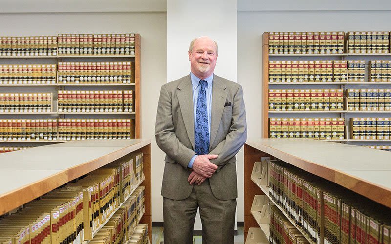 Attorney Doug Standing with Interlocking Hands