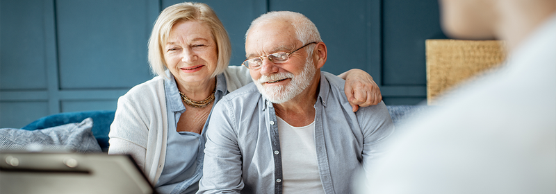 Happy senior couple during a meeting with agent