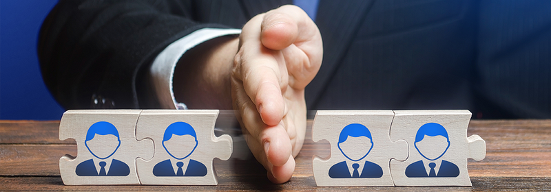 A man divides puzzle team of employees.