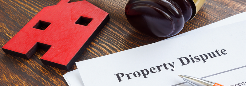 Property dispute documents, small home and gavel.
