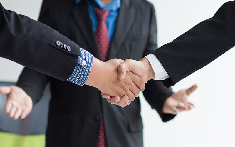 Businessman shaking hands after mediation 