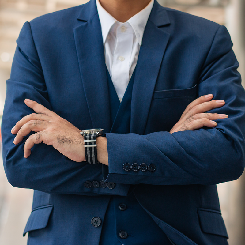 young businessman holding arms folded.