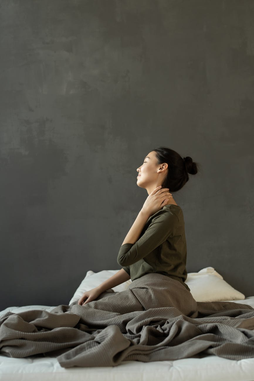woman holding her neck in pain