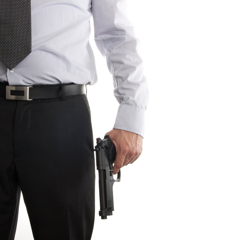 Man Holding a Handgun at His Side