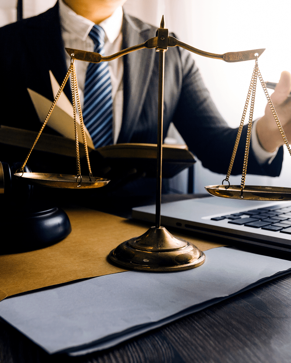 Justice and law concept.Male judge in a courtroom with the gavel,working with,digital tablet computer docking keyboard, eyeglasses,on wood table