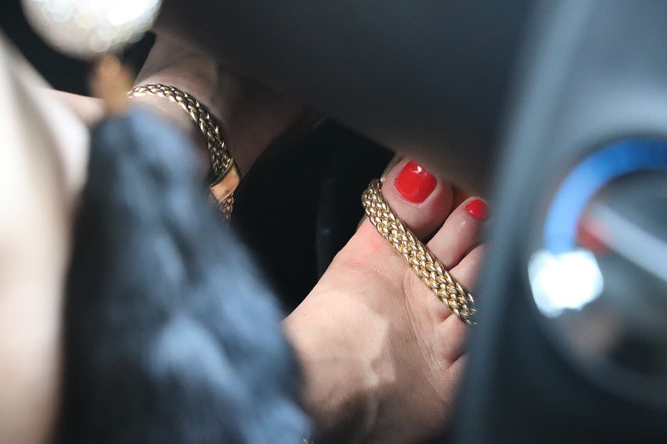 Woman Stepping on Gas Pedal