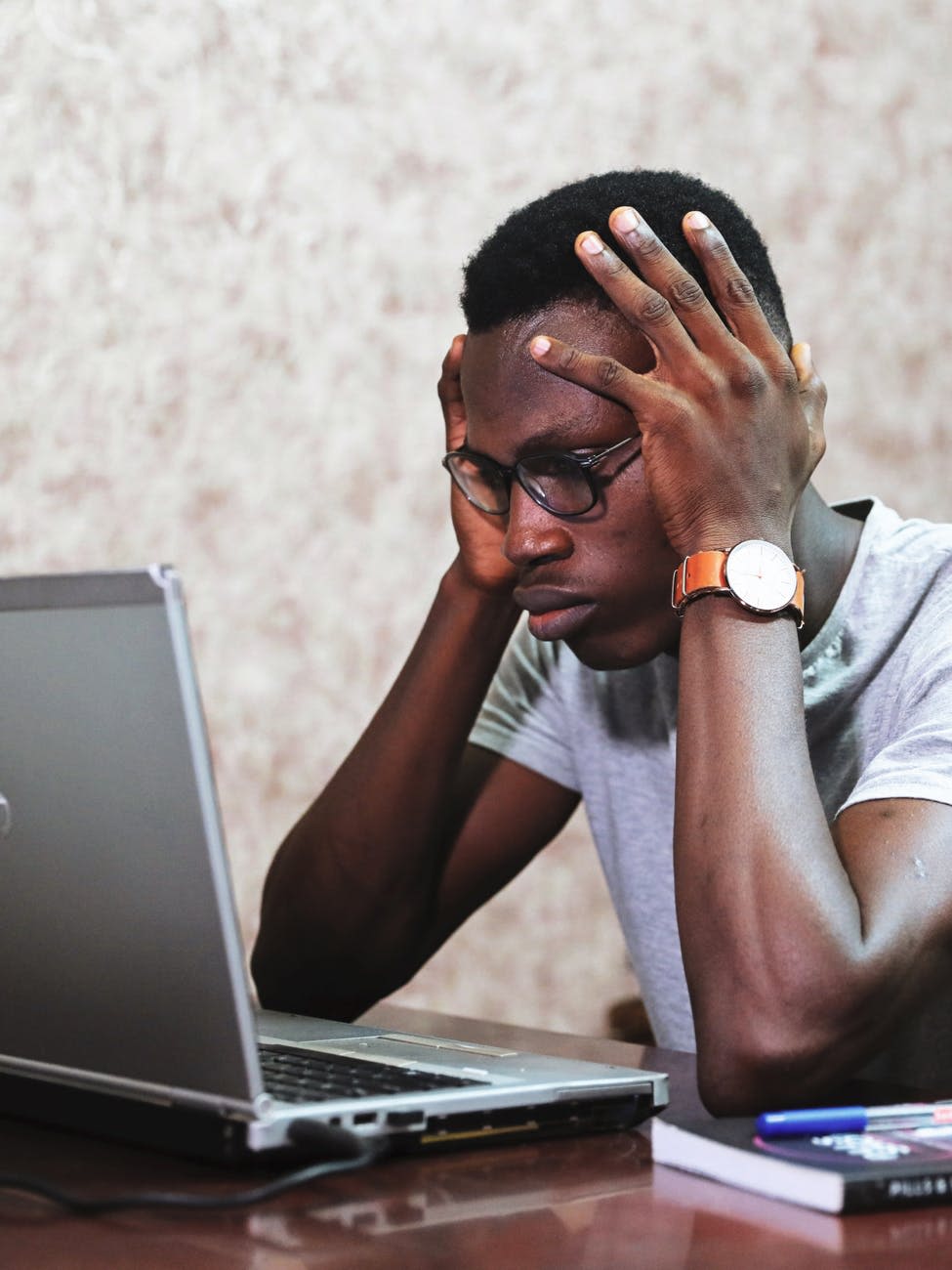 stressed out man looking at computer