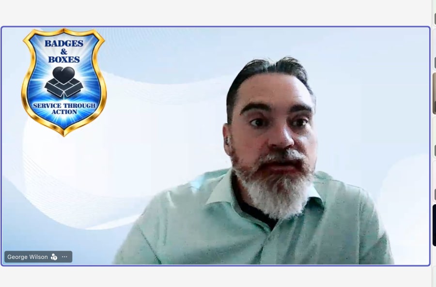 George Wilson presenting via video conference with the Badges & Boxes shield as his virtual background