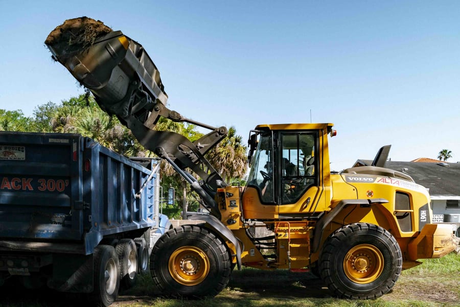 Branded Gator Creek dump truck hauling material