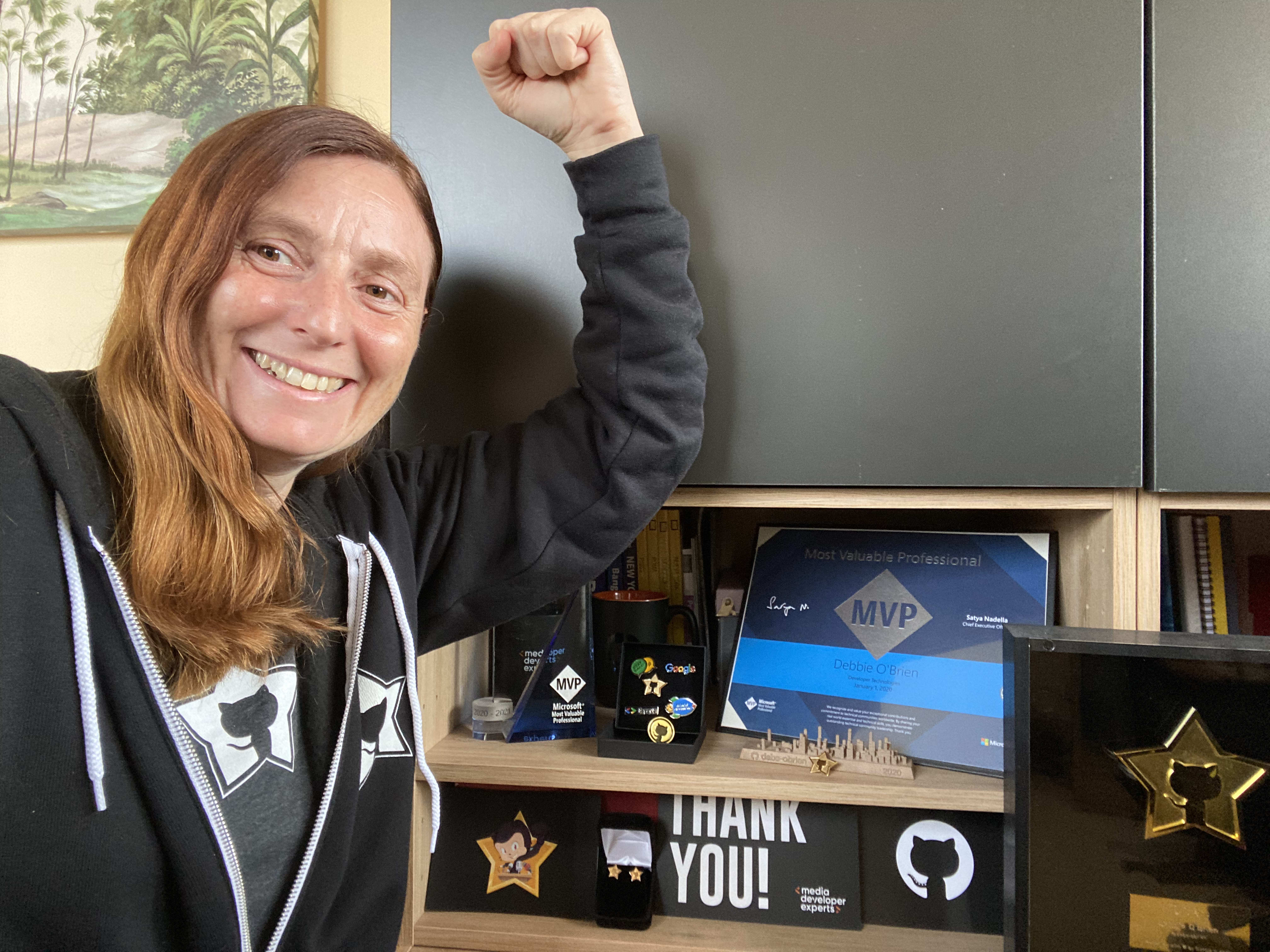 me with my GitHub swag and awards behind me