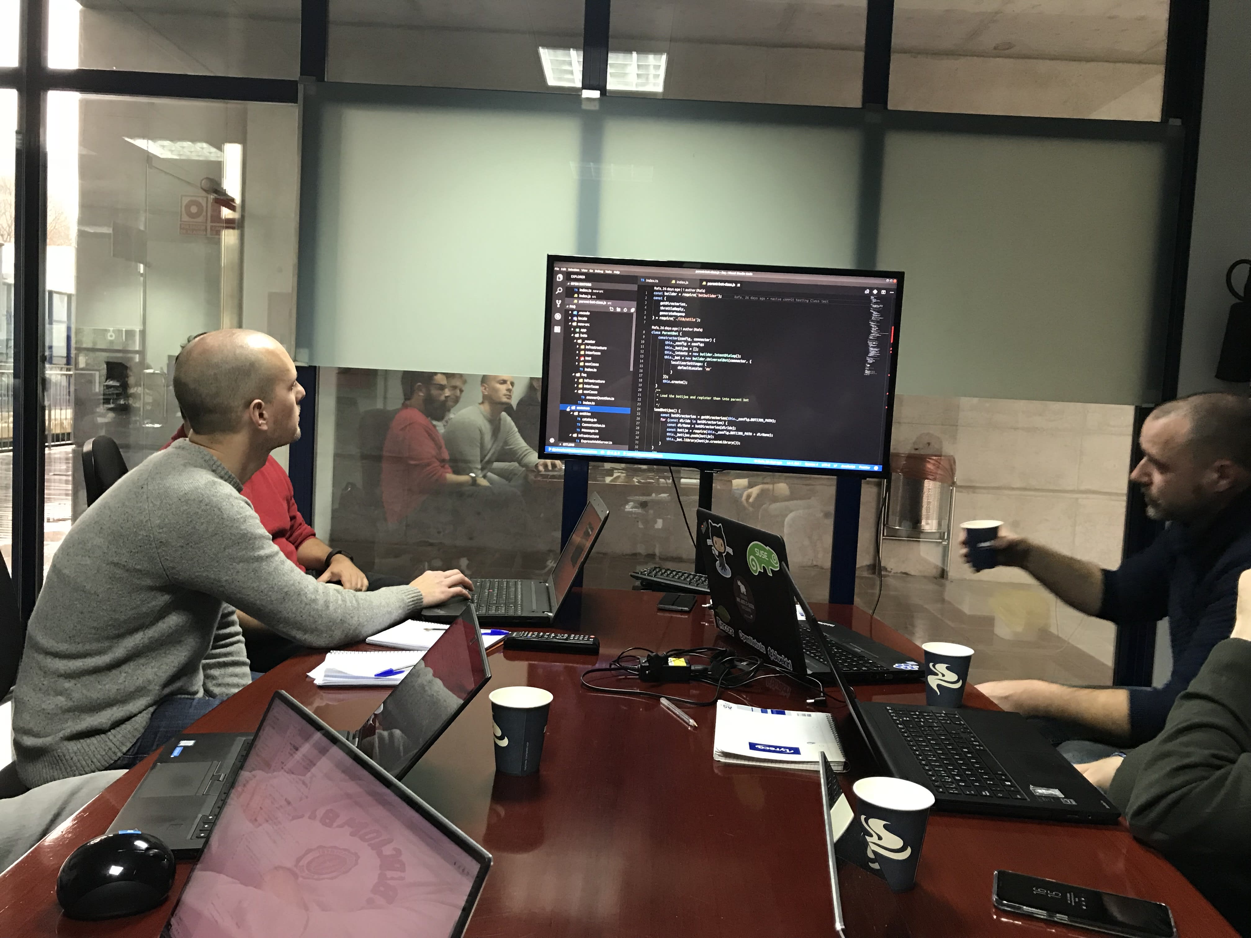 a group of developers building looking at a screen of code